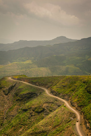 A truck hauling coffee beans on a winding road in Ethiopia