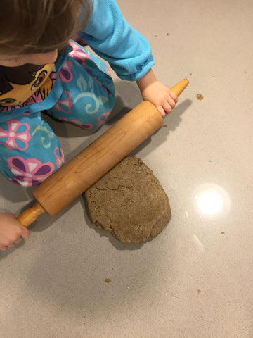 child with rolling pin