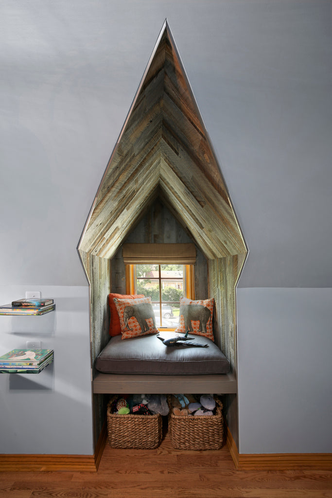 Reclaimed weathered wood Stikwood was used in this small reading nook that is pointed like a cathedral