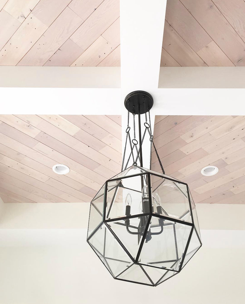 Wood Ceiling Planks are angled in coffered ceiling and paired with black geometric pendant light.