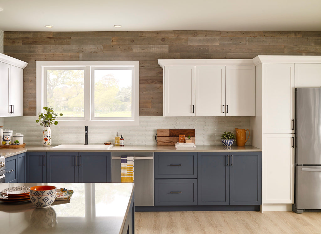Barn wood wall paneling inspired reclaimed wood decorates the top of a contemporary blue and white kitchen.