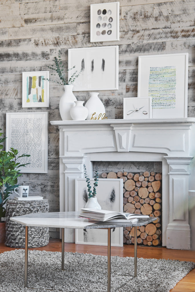 DIY fireplace surround made with white reclaimed wood panels and an ornate mantle