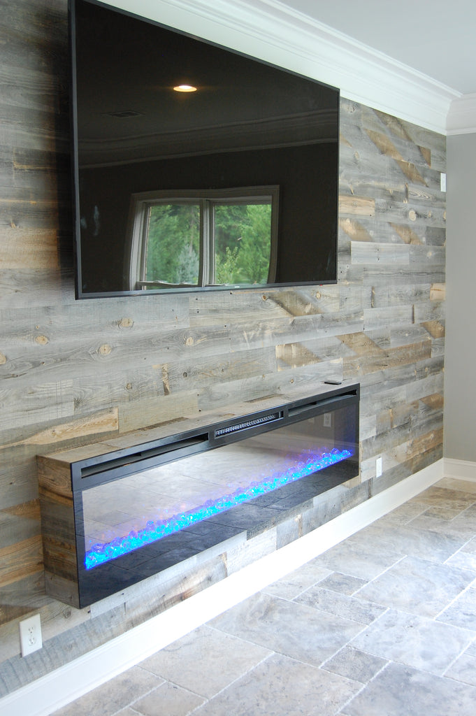 Rustic wood plank fireplace wall surrounds modern looking flat panel gas fireplace