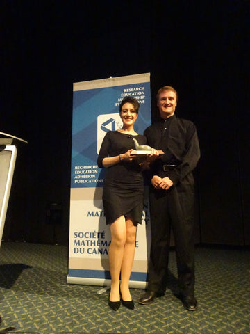 Stephanie accepting a prestigious math award in Movement Global sustainable organic cotton and bamboo dress