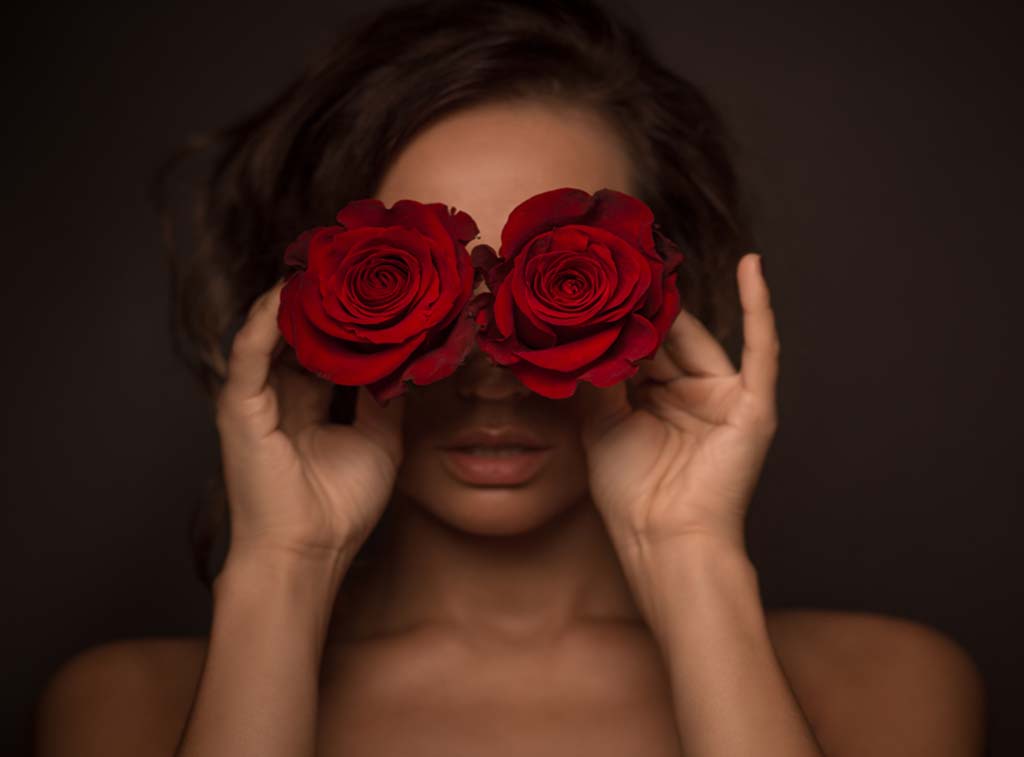 Sexy lover with roses covering her eyes