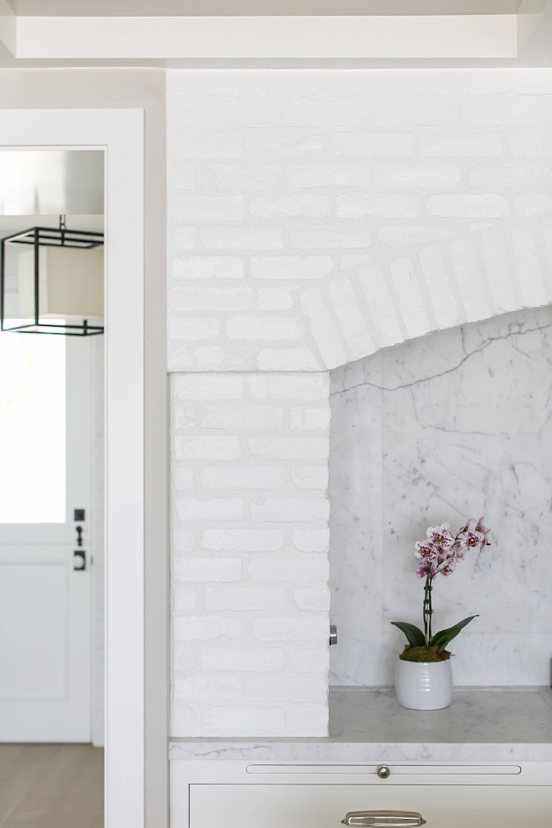 white brick and calcutta marble kitchen interior design