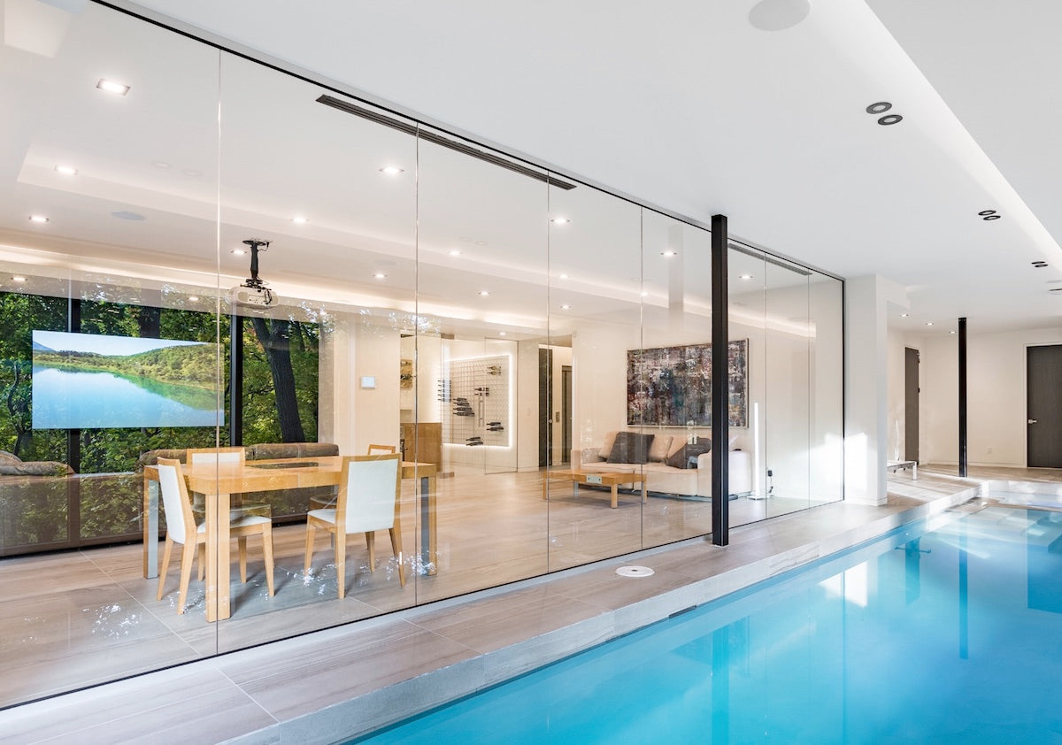 glass enclosed pool with wine room