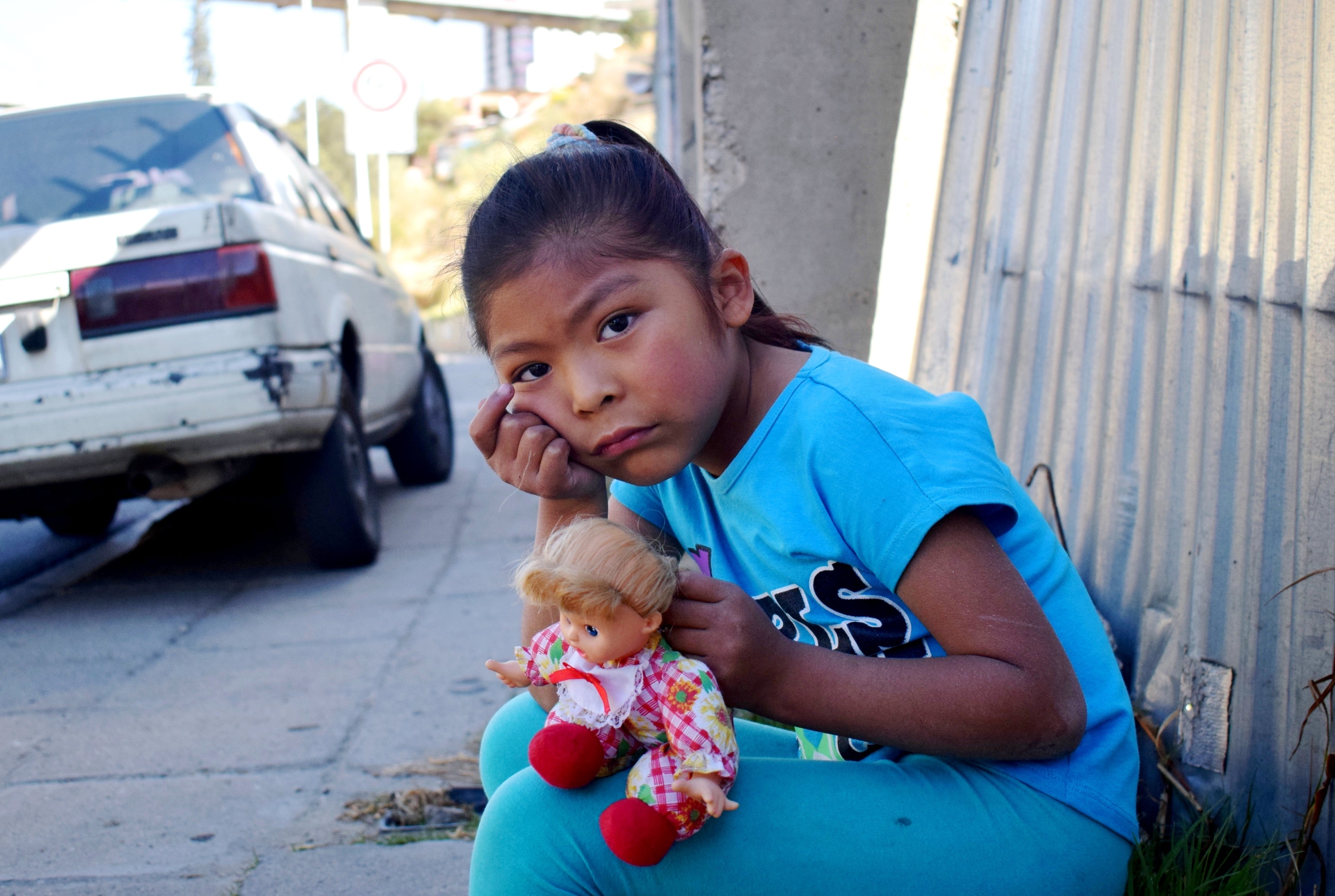 Image of a girl on the street thinking