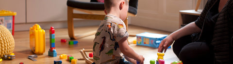 Image of a child playing with toys at a home from home place