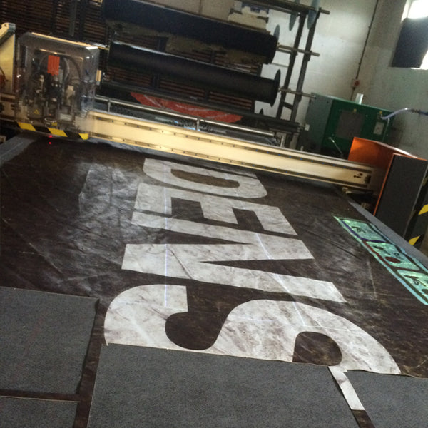 black lorry tarpaulin cutting by M24 bags, using a laser cutting machine