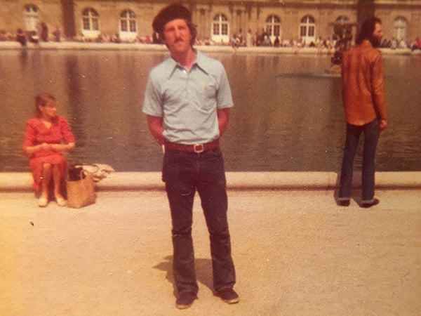 A man dressed in French-inspired travel clothing.