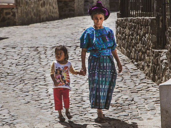 Weaver women with child Guatemala Mayalla huipil making