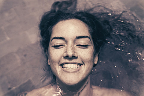 ragazza sorridente immersa nell'acqua