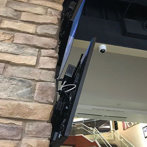 Intel NUC and external power brick mounted behind wall mounted TVs using HIDEit Uni-VESA Adapter and Uni-XS Mounts