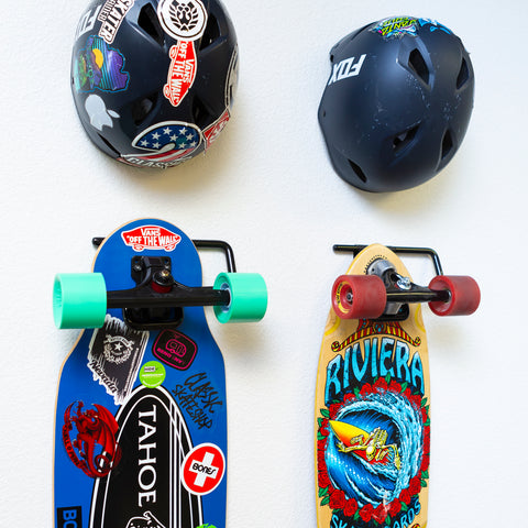 Two skateboards displayed on wall showing off their decks in HIDEit Display Skate Mounts.