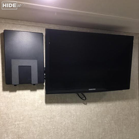Cable box wall mounted next to TV in Recreational Vehicle.