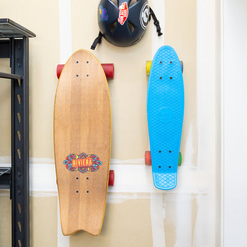 Riviera skateboard and penny board mounted in garage with HIDEit Vertical Skateboard Mounts.