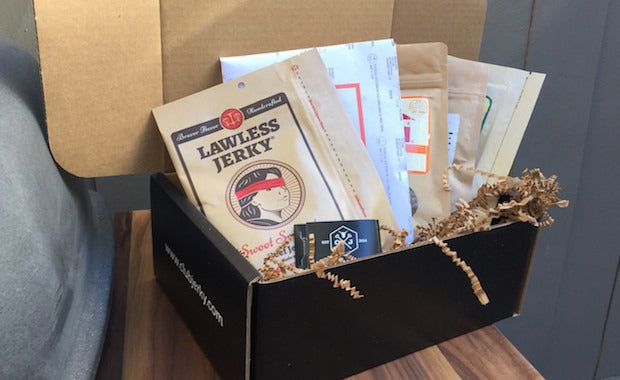 An open Club Jerky subscription box with jerky inside