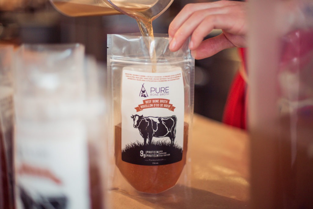 Pure Bone Broth being poured into a plastic package