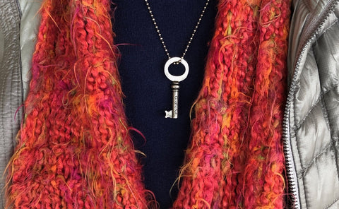 woman wearing key charm necklace