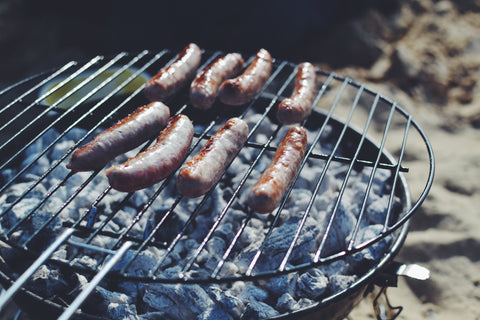 British BBQ with sausages over charcoal