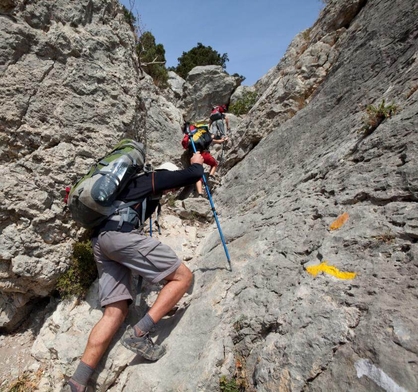 Mountain climbers climbing up a rocky route