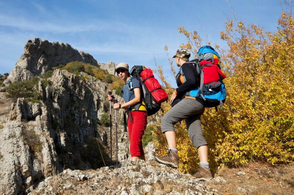 Two women backpacking in the mountains