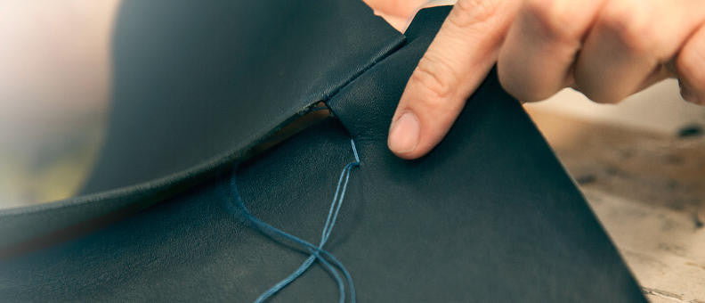 Vegetable-tanned leather being sewn with thread