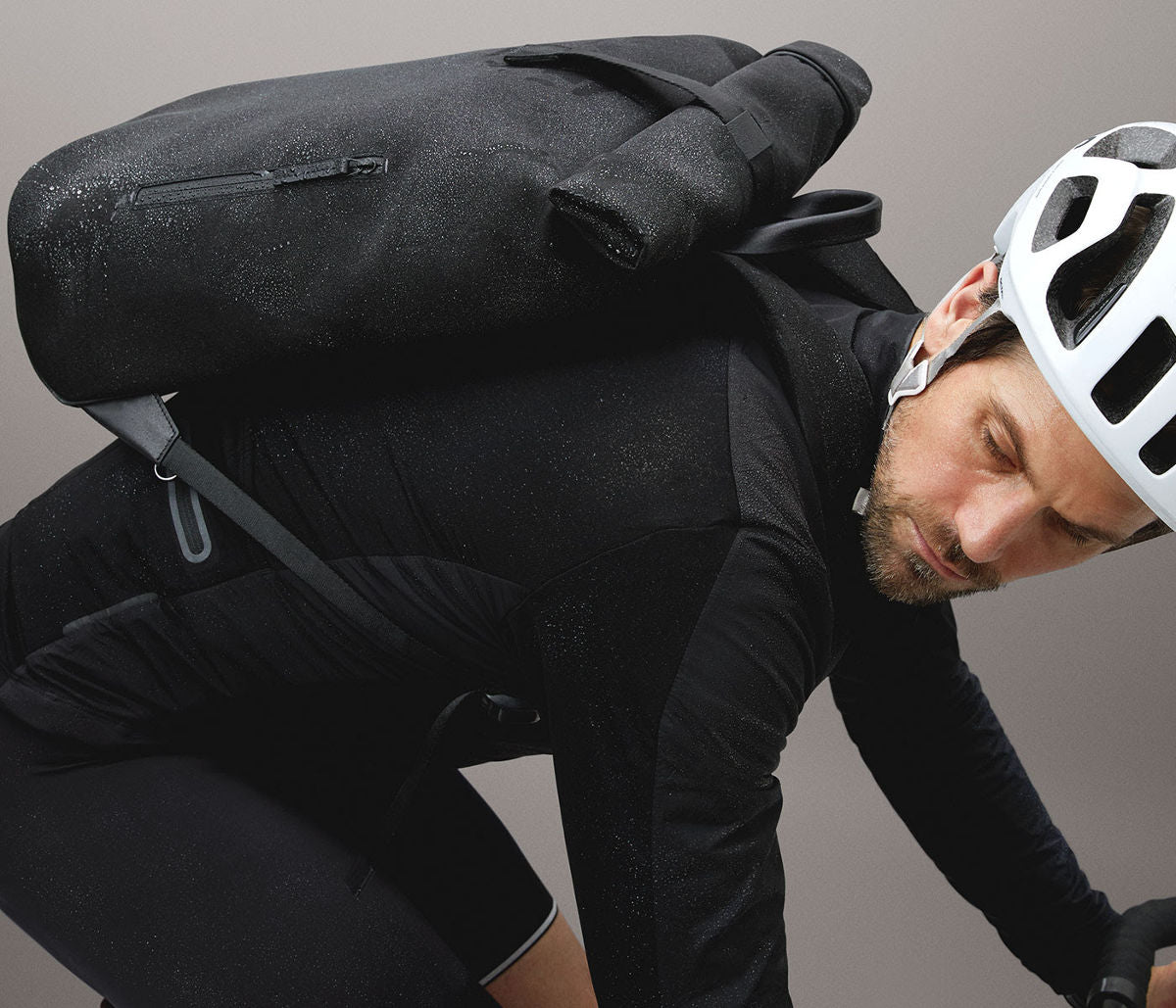Cyclist wearing black rolltop rucksack