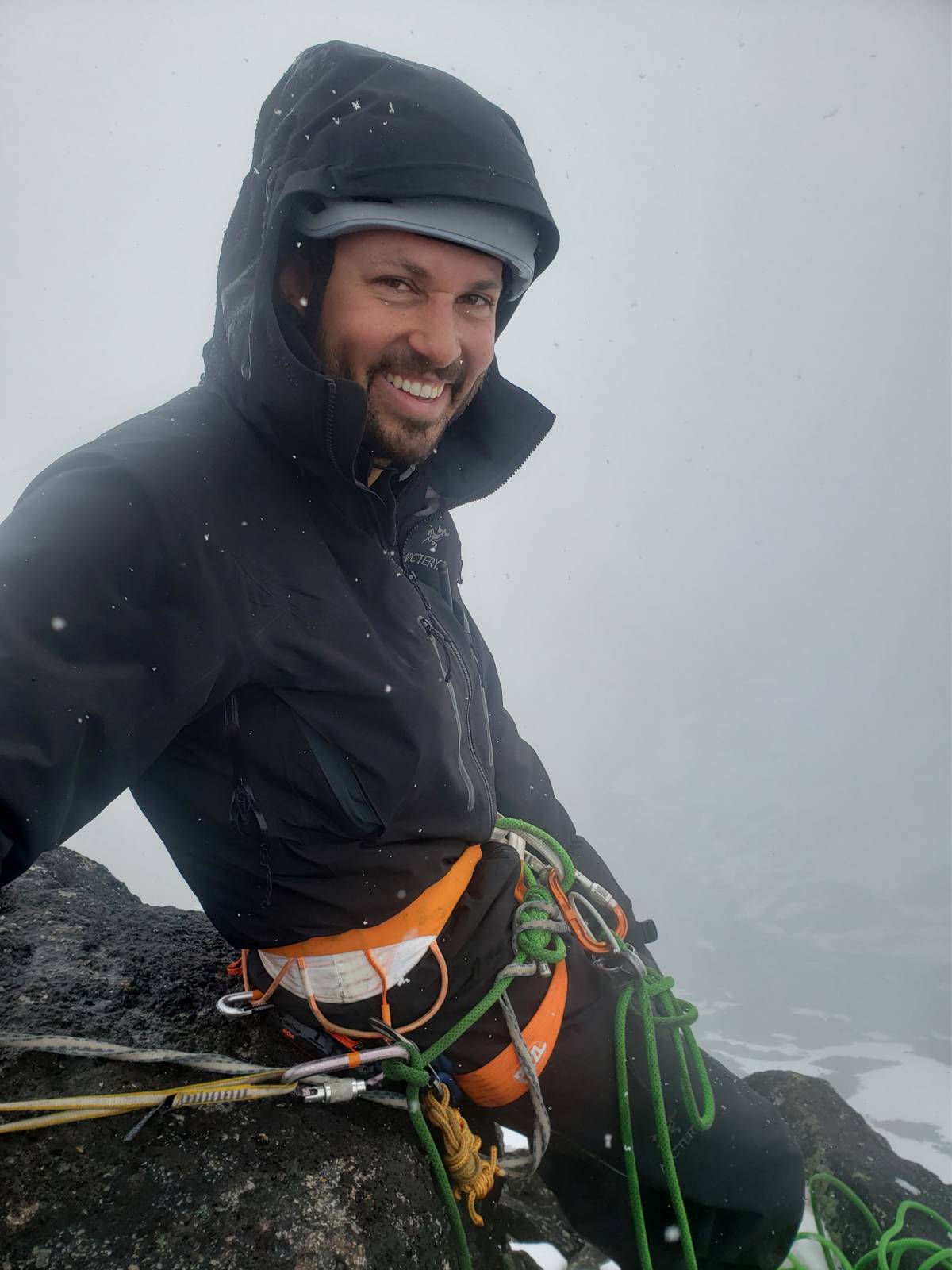 Samuel Bail, Troubadour co-founder, on a rock face in cold weather gear