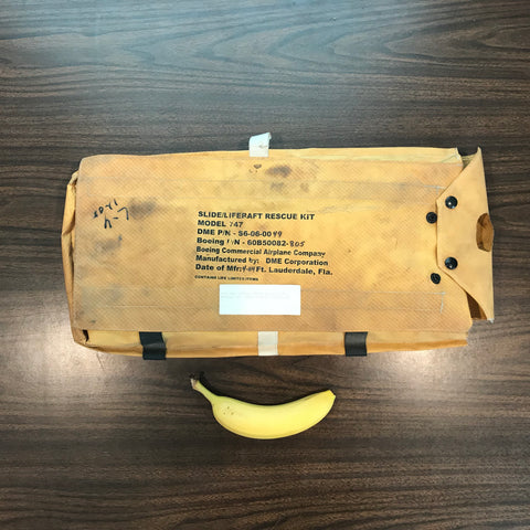 747 Passenger Jet Slide/Raft Rescue Survival Kit, shown next to a banana for scale.