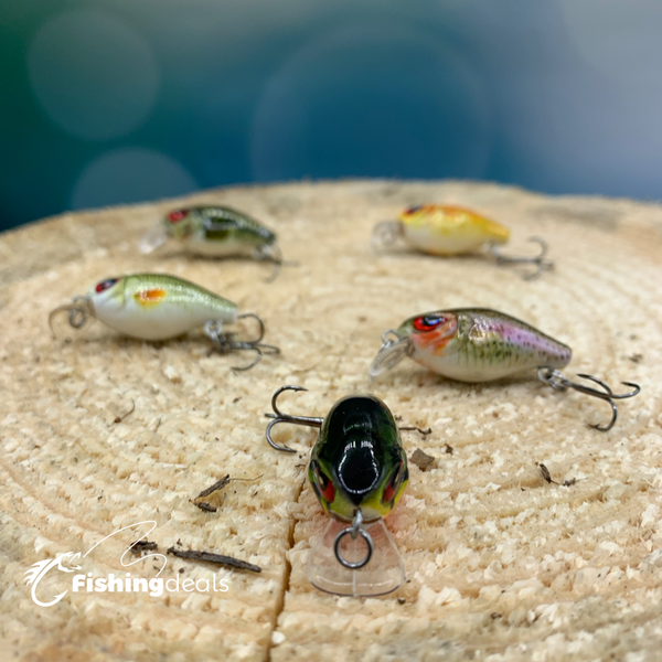 Five small fishing lures in different colors presented on wood