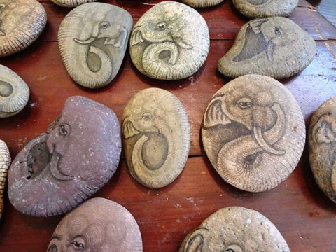Hand-painted rocks feature images of elephants