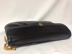 Vintage Christian Dior Vintage black leather clutch purse, mini bag, with golden Dior motif and gold tone chains.