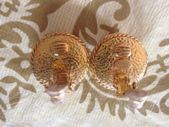 Vintage CHANEL gold tone round earrings with twisted frames, a faux pearl and CC motifs. Great and rare Chanel vintage jewelry gift.