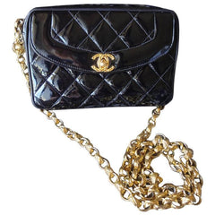 Vintage CHANEL quilted patent enamel leather black camera purse with golden chain strap and a ball