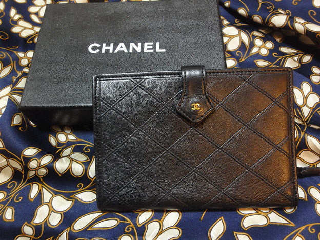 SOLD OUT: Vintage CHANEL goatskin black wallet with mini CC motif. Classic style that would never go out of style.