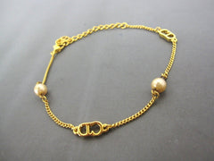 SOLD OUT: Christian Dior vintage faux pearl and gold tone skinny chain bracelet with CD charm. Best Gift