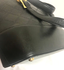 Vintage Gianni Versace black leather bolide shape handbag with a tassel and golden sunburst charms. Lady Gaga style.