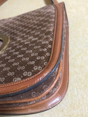 Vintage Gucci brown leather micro GG print shoulder bag with iconic golden large round GG motif. Rare masterpiece purse.