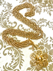 Vintage CHANEL double golden skinny chain long necklace with arabesque petal flower motif CC pendant top. Classic jewelry.