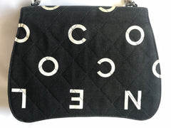Vintage CHANEL black fabric canvas handbag with silver tone chain strap and white Chanel CC logo print all over. Very unique shape.