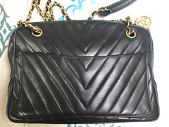 Vintage CHANEL black V, chevron stitch chain shoulder bag with golden round CC mark charm. Classic and simple shape purse.