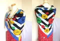 Vintage Chanel black and white geometric pattern and red, yellow, blue and green camellia flower prints silk scarf. Mod and chic wrapping.