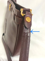 Vintage Cartier kelly style wine leather shoulder bag with a decorative built-in belt. les must de cartier collection.