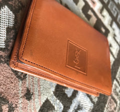 Vintage Yves Saint Laurent brown and khaki leather coin wallet with YSL logo embossed motif at front.