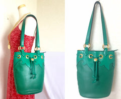 Vintage Christian Lacroix genuine grained green leather hobo bucket shoulder bag with golden sun motifs. Hot masterpiece