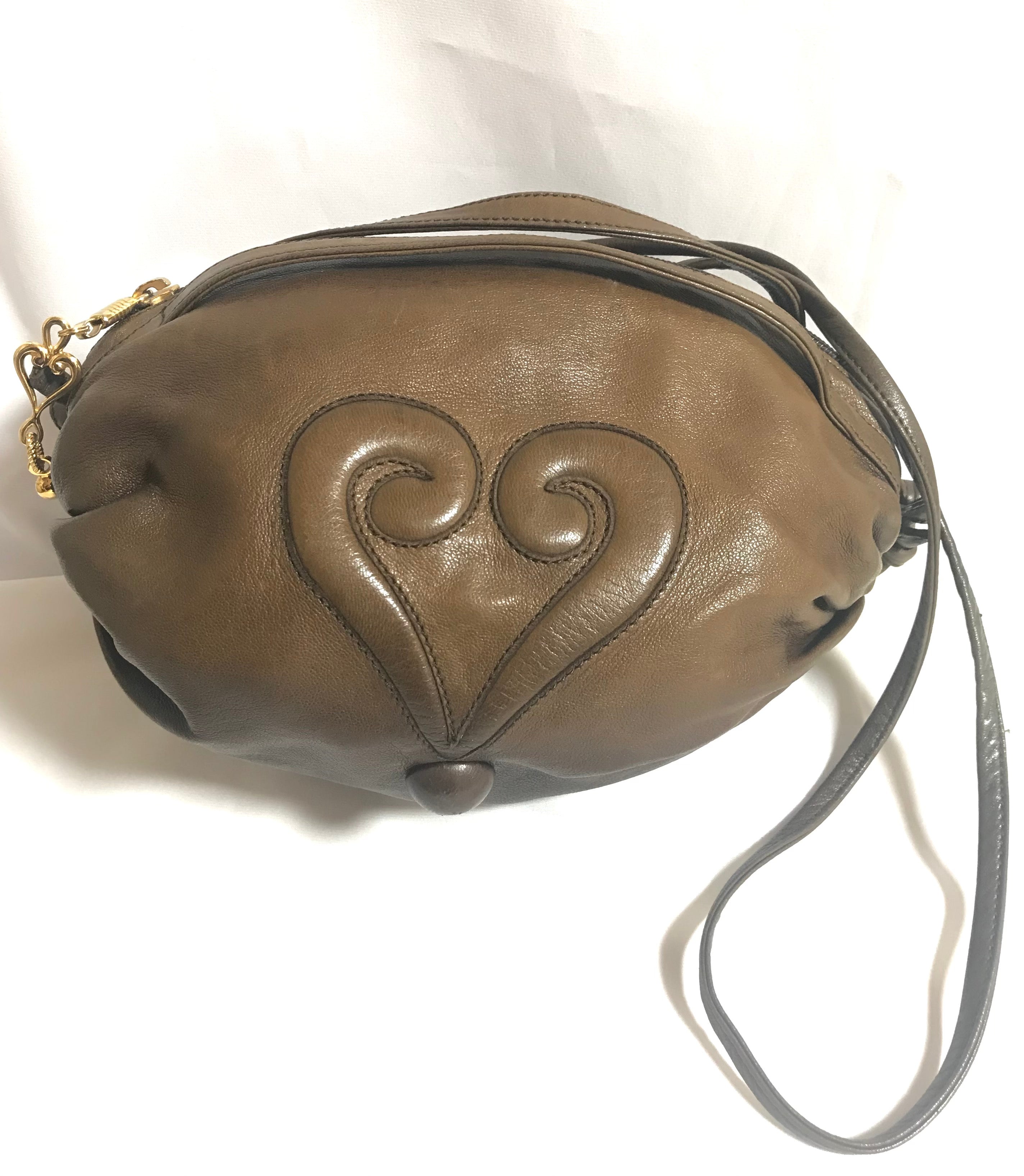 Vintage Moschino soft brown leather drum shape shoulder bag with iconic Question marks. Moschino by Redwall. Made in Italy.