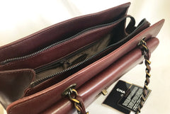 Vintage CHANEL wine chocolate brown leather shoulder bag with copper finished chains and CC closure. Classic and daily use bag.