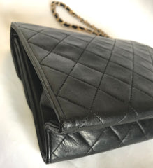 Vintage CHANEL black leather double envelop style flap shoulder bag with chain strap and fringe.